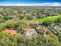 Overhead shot showcases a stunning estate surrounded by golf course views, lush greenery, and a community pool at 5067 Latrobe Dr, Windermere, FL 34786