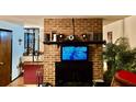 Living area featuring a charming brick fireplace, creating a warm and inviting atmosphere at 527 Leland Dr, Deltona, FL 32725