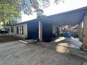 Spacious carport area providing covered parking and extra storage space for outdoor equipment at 5298 Rose Ave, Orlando, FL 32810