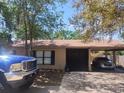 Front view of a single story home with a carport and a blue truck in the driveway at 5298 Rose Ave, Orlando, FL 32810