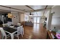 Inviting living space with hardwood floors, a decorative room divider, and natural light filtering through glass doors at 6222 Dovecrest Trl, Lakeland, FL 33810
