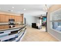 Bright kitchen with a breakfast bar overlooking the living room at 640 Brookfield Pl, Apopka, FL 32712