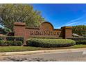 A brick sign for the Remington community amidst lush greenery, suggesting a well-maintained neighborhood at 654 Chadbury Way, Kissimmee, FL 34744