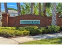 Brick sign for Windsor Park community with manicured hedges, suggesting a well-maintained neighborhood at 654 Chadbury Way, Kissimmee, FL 34744