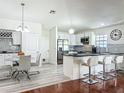 Modern kitchen features white cabinets, stainless steel appliances, and a breakfast bar at 6559 Grosvenor Ln, Orlando, FL 32835