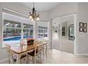 Bright dining area with pool view, neutral colors, and sliding doors to the patio at 736 S Lake Claire Cir, Oviedo, FL 32765