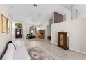 Open-concept living room with wood floors, vaulted ceiling, and abundant natural light at 736 S Lake Claire Cir, Oviedo, FL 32765