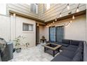 Private patio features pavers, a comfortable seating area, and stylish outdoor lighting at 85 Carolwood Blvd, Fern Park, FL 32730