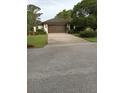 Attached garage with wide driveway and beautiful, mature landscaping at 1 Huntley Ct, Haines City, FL 33844