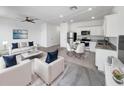 Bright, open-concept living room and kitchen with modern furnishings and stainless steel appliances at 1112 Merrill St, Davenport, FL 33837