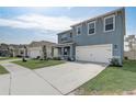 Charming two-story home featuring a two car garage, delightful exterior, and well-maintained lawn at 11279 Amber Ridge Dr, Zellwood, FL 32798