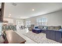 Inviting open-concept living space with tile flooring, blending kitchen, dining, and living areas at 11279 Amber Ridge Dr, Zellwood, FL 32798