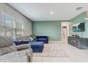 Open-concept living room with tile flooring, cozy furniture, and lots of natural light at 11279 Amber Ridge Dr, Zellwood, FL 32798