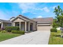 Lovely single-story home features manicured lawn, mature trees, and a covered front porch at 1155 Seburn Rd, Apopka, FL 32703