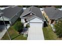 Aerial view of a single Gathering home featuring a two car garage and nice landscaping at 118 Hurst Ct, Deland, FL 32724