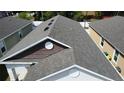 Aerial detail of roof on single Gathering home, featuring newer shingles and ventilation at 118 Hurst Ct, Deland, FL 32724