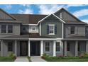 Attractive townhome with neutral-toned siding, a covered entrance, and a well-maintained lawn at 13528 Autumn Harvest Ave, Winter Garden, FL 34787
