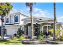 Beautiful home featuring landscaped front yard, stone accents and a columned porch at 13722 Fox Glove St, Winter Garden, FL 34787