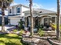 Beautiful home featuring landscaped front yard, stone accents and a columned porch at 13722 Fox Glove St, Winter Garden, FL 34787
