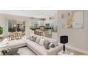 Open-concept living room with a modern sofa, dining area, and kitchen with stainless steel appliances at 14040 Helsby St, Orlando, FL 32832