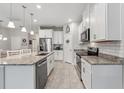 Bright kitchen featuring granite countertops, stainless steel appliances, and tiled floors at 15456 Blackbead St, Winter Garden, FL 34787