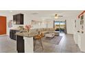 Cozy living room with a breakfast bar and sliding door access to the patio at 1579 Swan Lake Cir, Dundee, FL 33838