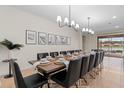 Dining area with long wooden table, black chairs, and decorative lighting for elegant dinners at 1639 Lima W Ave, Kissimmee, FL 34747