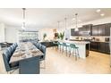 Open concept living area with long dining table, kitchen island with seating, and view of backyard at 1639 Lima W Ave, Kissimmee, FL 34747