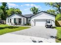 Charming single-Gathering home features a landscaped front yard, golf cart, and an attached two-car garage at 1806 Paloma Ave, Sanford, FL 32771