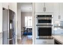Stainless steel kitchen appliances with view of dining area featuring window views at 2011 Soaring Oak Way, Winter Park, FL 32792