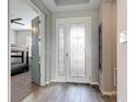 Bright foyer featuring a decorative glass front door and wood-look tile flooring at 231 Cherokee Hill Ct, Deland, FL 32724