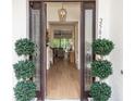 View from the front door into the home, showcasing the beautiful hardwood floors and stylish decor at 25813 Feather Ridge Ln, Sorrento, FL 32776