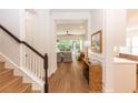 Bright foyer showcases beautiful wood floors, elegant trim, and an open view into the living and dining area at 25813 Feather Ridge Ln, Sorrento, FL 32776