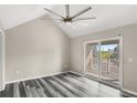 Spacious bedroom features high ceilings, updated flooring, ceiling fan, and balcony access at 2694 Giardino Loop, Kissimmee, FL 34741