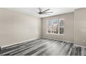 Bright bedroom features updated flooring, a ceiling fan, and a large window at 2694 Giardino Loop, Kissimmee, FL 34741