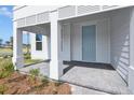 Covered front porch featuring classic white columns and a light-blue front door at 3002 Voyager Ave, St Cloud, FL 34771