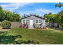 Cozy home with vibrant landscaping set against a lush green lawn and privacy fence at 3151 S Bumby Ave, Orlando, FL 32806