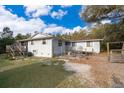 Home's backyard with a small fenced yard and deck and stairs on the side at 38851 Forest Dr, Eustis, FL 32736