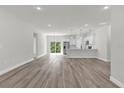 Spacious living area with wood floors flowing into the kitchen with stainless steel appliances at 3984 Sw 151St St, Ocala, FL 34473