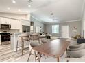 Open-concept living space with a seamless connection to the kitchen and dining area, filled with natural light at 501 Mulberry St, Fruitland Park, FL 34731
