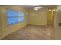 Inviting living room with tile flooring, bright walls and natural light at 6427 Breezewood St, Orlando, FL 32818