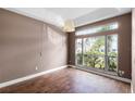 Cozy bedroom featuring natural light, wood-look tile flooring and a large window at 745 Riggs Cir, Davenport, FL 33897