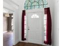 Elegant front door with decorative glass, sidelights, and beautiful tiled flooring at 745 Riggs Cir, Davenport, FL 33897