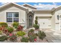Inviting home entrance with well-manicured landscaping, stone mulch, and a charming front door at 9210 Sw 60Th Court Rd, Ocala, FL 34476