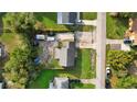 Aerial view of a home showcasing its roof, driveway, surrounding greenery, and neighboring properties at 1491 Lavender St, Deltona, FL 32725