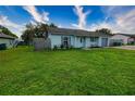 Charming single-story home featuring light blue siding, an attached garage and a well-maintained lawn at 1491 Lavender St, Deltona, FL 32725