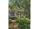 Quaint one-story house featuring a covered front porch with decorative trellis at 15 W Vanderbilt St, Orlando, FL 32804