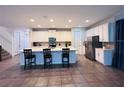 Modern kitchen with an oversized island, stainless steel appliances, and sleek white cabinets at 1790 Sawyer Palm Pl, Kissimmee, FL 34747