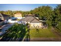 An aerial view of a well-maintained home featuring a lush lawn, landscaping, and backyard privacy fence at 1878 Durban Way, Apopka, FL 32712