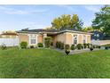 Beautiful one-story home featuring lush green lawn, mature landscaping, and a charming, well-maintained exterior at 1878 Durban Way, Apopka, FL 32712